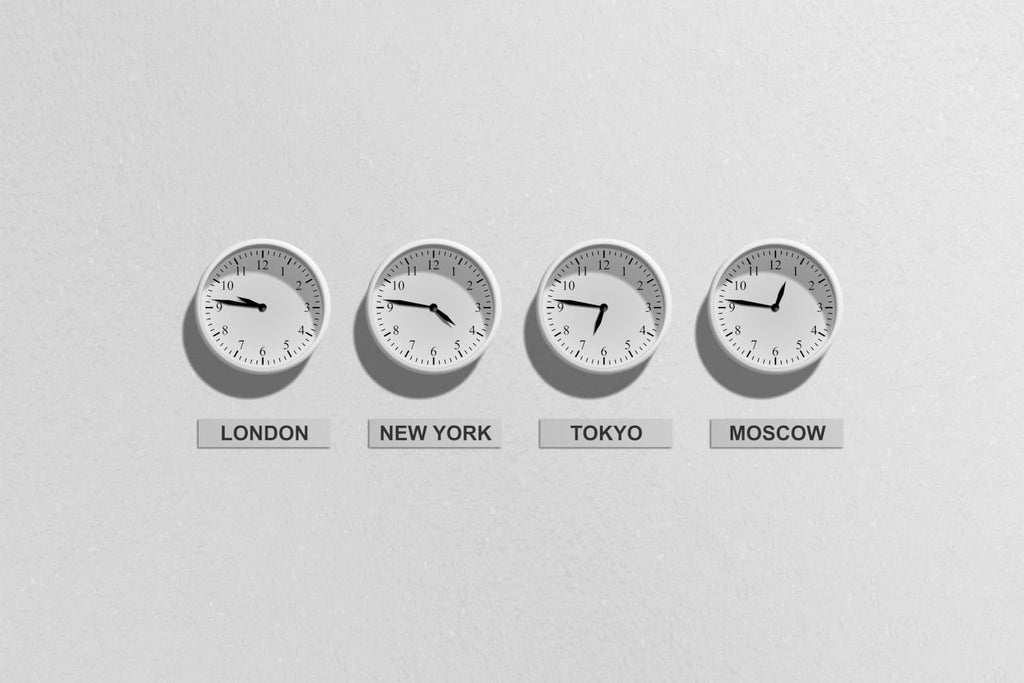 Wall clocks hanging, showing local times for different cities